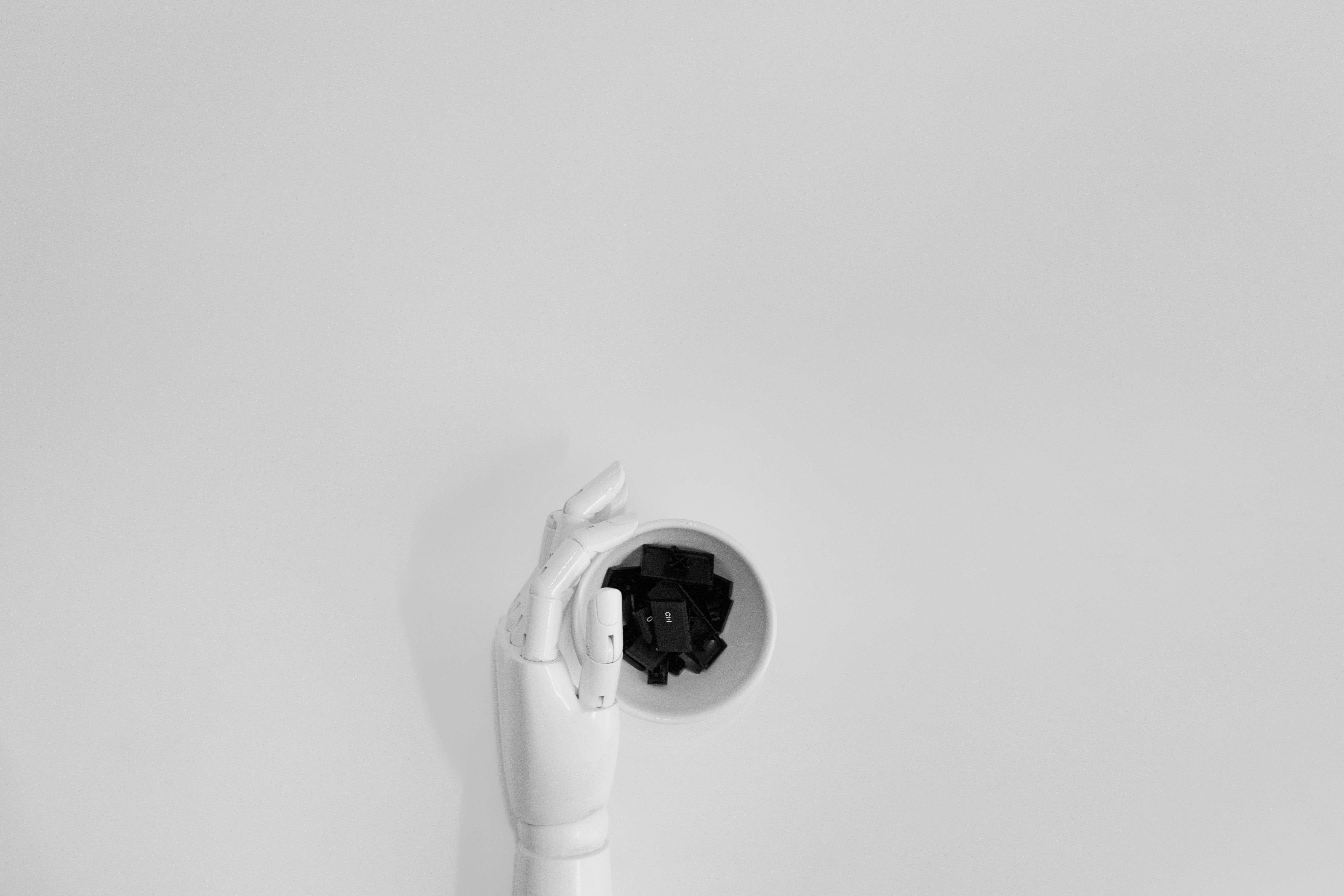 Robotic hand typing on a keyboard, representing AI-generated text